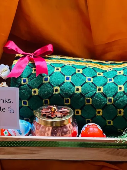 A thank you gift hamper featuring a beautiful green quilted pouch and a decorative jar. The simple "Thanks. Smile" note adds a warm, personal feel.
