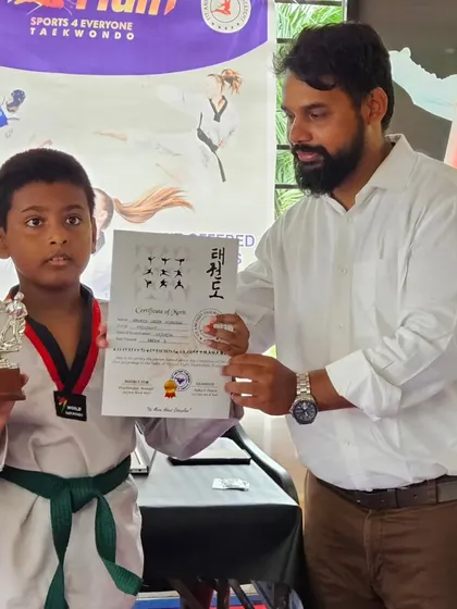 Rashid is awarded the "Best Fighter" trophy during the 2024 belt promotion exam. We recognize students who show exceptional skill and spirit.