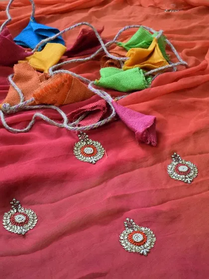 This ombre-dyed saree in shades of pink and orange is embellished with delicate Kundan work motifs. I believe in enhancing the beauty of a saree with details that catch the light and the eye.