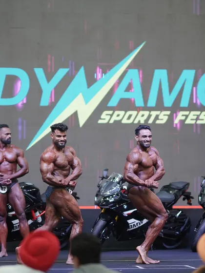 A side tricep pose on the championship stage. This pose shows the detail and separation that a proper cutting phase can bring.