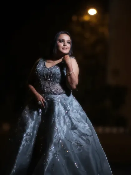 A full-length portrait of the bride in her beautiful gown, captured at night. The dramatic lighting makes her stand out and creates a very cinematic feel.