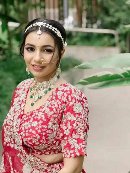 A close-up portrait that captures the bride's radiant smile and the beautiful details of her makeup and jewelry.
