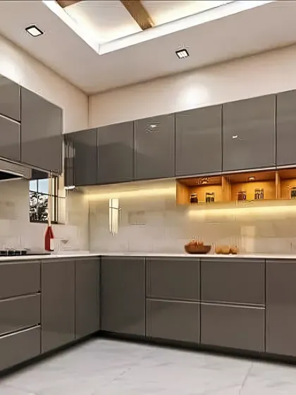 A contemporary L-shaped kitchen with handleless grey glossy cabinets and a built-in oven. The design includes open wooden shelves with accent lighting for a warm contrast.