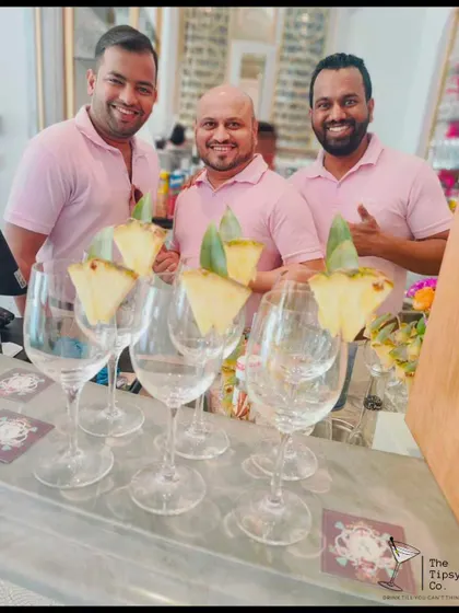 Our team serving up refreshing pineapple-garnished drinks. We work together to ensure every drink is perfect and every guest is happy.