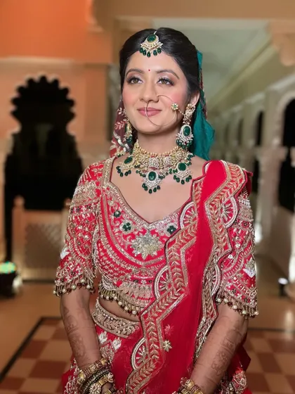 A radiant bride with her hair in a classic, neat bun. This timeless hairstyle is perfect for a traditional wedding look, ensuring all attention is on her beautiful smile and outfit.