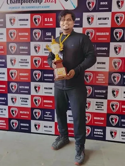 Our coach holding a championship trophy, a symbol of the entire team's collective effort and success.