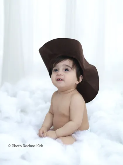 A simple and sweet portrait from the celestial shoot, with the toddler wearing a cowboy hat amidst the clouds.
