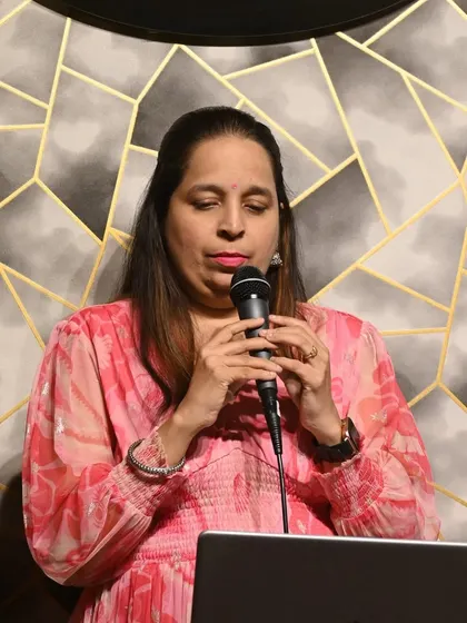 A student practicing her song during a karaoke session. Our studio provides a professional setup for students to hone their performance skills.
