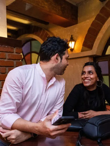 A candid moment between two guests enjoying the night at Watson's Vasanthnagar.