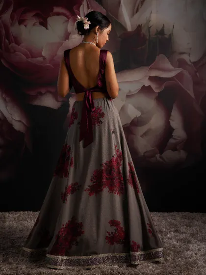 Step into my world, where bright bougainvilleas against shadowy skies serve as inspiration. This grey lehenga with red floral prints is an interpretation of my love for monsoons.