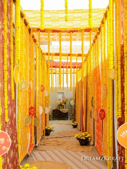 A vibrant walkway decorated with strings of yellow marigolds, creating an immersive and traditional entrance for the Haldi ceremony.