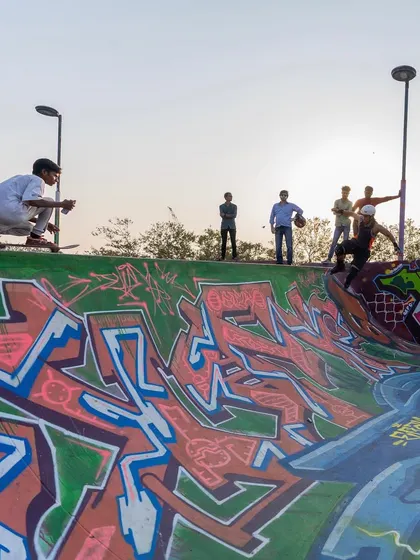 A skater mid-air against a backdrop of my crew's graffiti work. This is the intersection of street art and street sports, two cultures with deep roots.