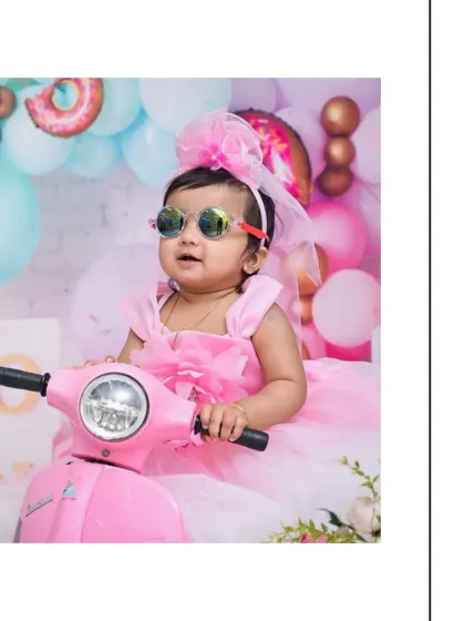 A close-up shot of this cool little girl on her pink scooter, wearing sunglasses. This 'Candy Land' theme is all about fun, color, and capturing a playful attitude.