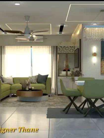 A vibrant living and dining room design featuring olive green sofas and chairs. The space is illuminated by a grand crystal chandelier and linear ceiling lights, creating a luxurious and inviting environment.