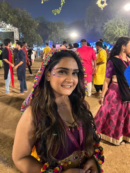 A happy Garba-goer with a sweep of pink and silver glitter across her cheekbone.