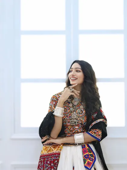 A candid moment of joy. Her Navratri makeup is subtle, with a focus on flawless skin, allowing her happy expression and beautiful outfit to take center stage.