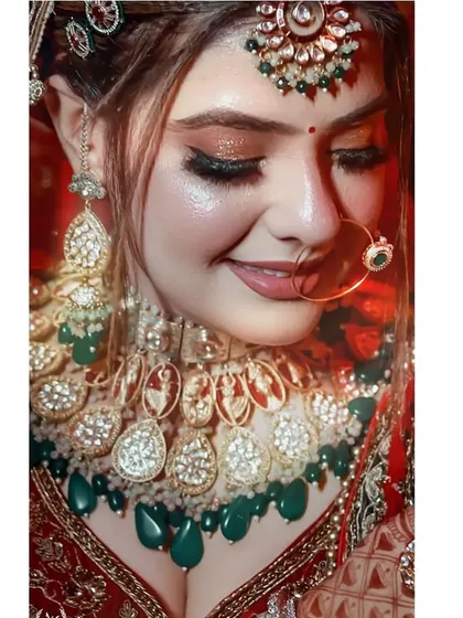 A smiling close-up of the bride, highlighting her nath and the stunning polki necklace.