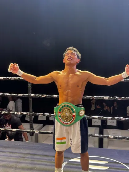 The emotion of victory. A champion raises his arms after a hard-fought battle.
