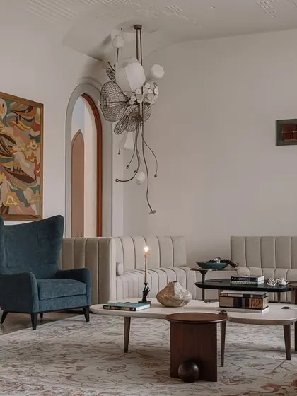 The formal living room at Rehethaan is a study in sophisticated comfort. We used a mix of custom sofas, elegant wingback chairs, and sculptural coffee tables, all set under a ceiling with intricate gypsum embroidery and bespoke chandeliers.