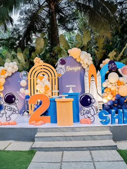 The full stage setup for a second birthday "Trip Around the Sun." The outdoor setting combined with our space decor created a fantastic party atmosphere.