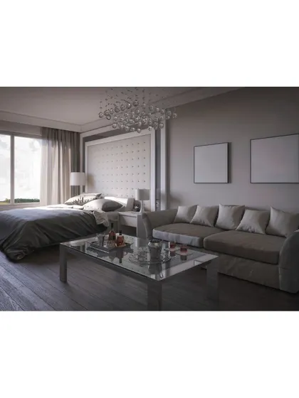 A hotel-like master suite设计 that combines the bedroom and a small living area. The tufted headboard, glass coffee table, and bubble chandelier create an atmosphere of pure luxury.