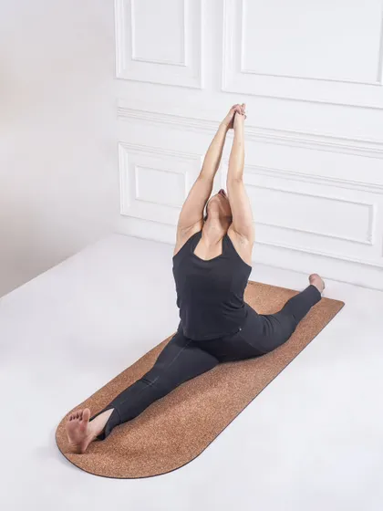 Another perspective of Hanumanasana, with arms raised. This variation adds a heart-opening element to the deep hamstring and hip-flexor stretch.
