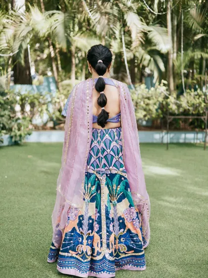 A view of the unique bubble braid hairstyle, perfect for a fun Mehendi or Haldi event. It's modern, playful, and keeps the hair neatly styled.