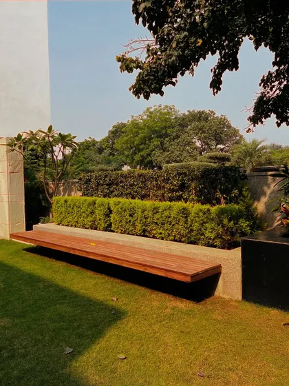 Another view of the custom floating bench, showcasing its clean lines and the contrast between the warm wood and the cool stone base. Simple, elegant design is a hallmark of my work.