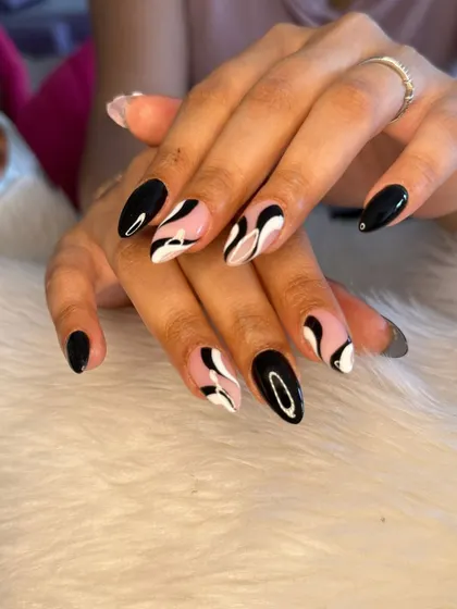 Another shot of the striking black and white abstract swirl nails.