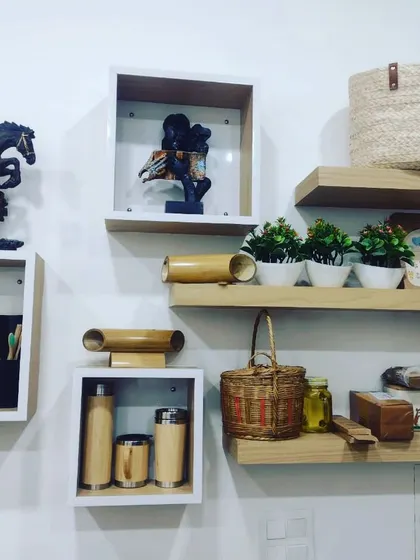 Our products displayed on shelves, showing how they can be used to create an attractive retail or corporate gift display. This setup includes our bamboo flasks, speakers, baskets, and stationery.