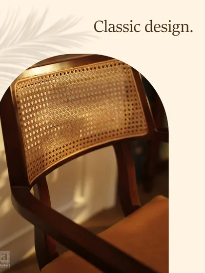 A detail shot capturing the beautiful texture and pattern of the handwoven cane backrest, illuminated by natural light. This traditional craft is central to many of our signature pieces.