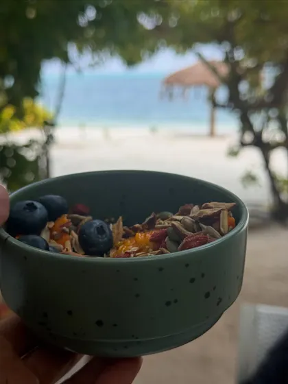 Nourishing our bodies with healthy and delicious food is key. We enjoy fresh fruit platters, wholesome granola, and local delicacies like this traditional meal served on a banana leaf.