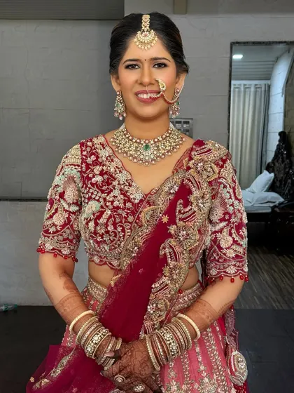 A full-shot showing the complete look. The makeup ties together the entire ensemble, from the jewelry to the lehenga.