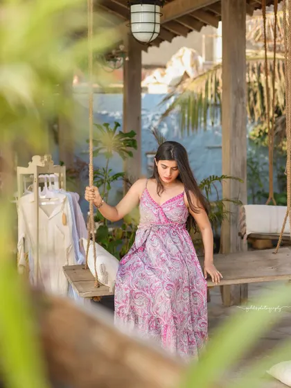 A collection of relaxed, bohemian-style portraits taken at a rustic cafe. The model is featured in a flowing paisley dress, interacting with props like a guitar, creating a natural and artistic vibe.