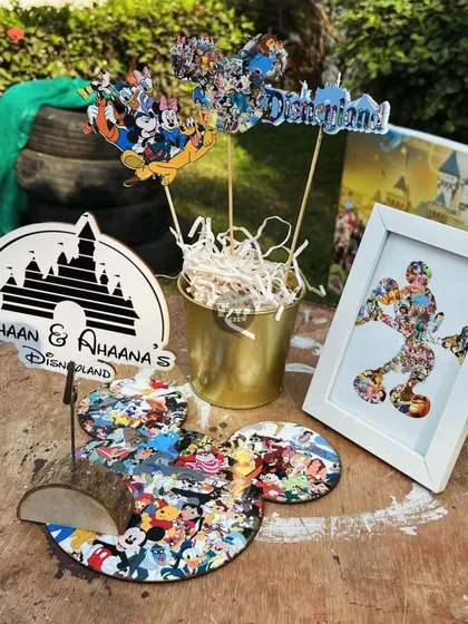 A custom Disneyland-themed centerpiece, featuring a Mickey Mouse silhouette made from a collage of Disney characters.
