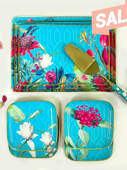 The Chilean Deco collection is designed to leave a lasting impression with its bold turquoise and fuchsia floral patterns. This set of trays and canisters makes for a luxurious and unforgettable gift.