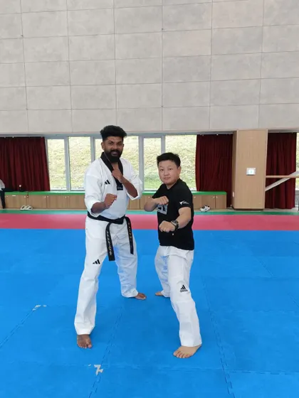 Sharing a fighting stance with another international participant. Taekwondo is a universal language.