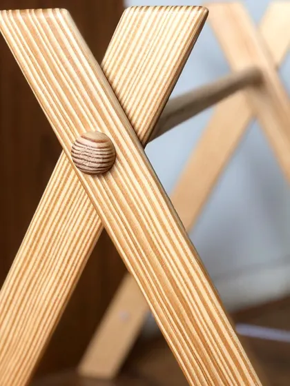 A close-up of the play gym's construction. I pay close attention to details like the smooth wooden knobs and sturdy A-frame design to ensure it is completely stable and safe for your baby.
