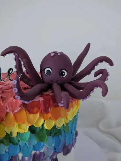 The friendly purple octopus that sat atop the rainbow cake, another one of the birthday boy's favorites.