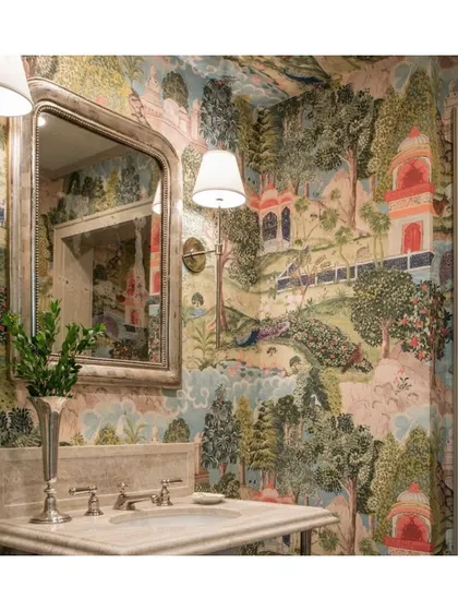 This powder room is wrapped entirely in an exotic, bold, and colorful scenic wallpaper. Designed by Lucas Eilers, this space shows how a small room can be transformed into a dreamy and transportive environment with the right wallcovering.