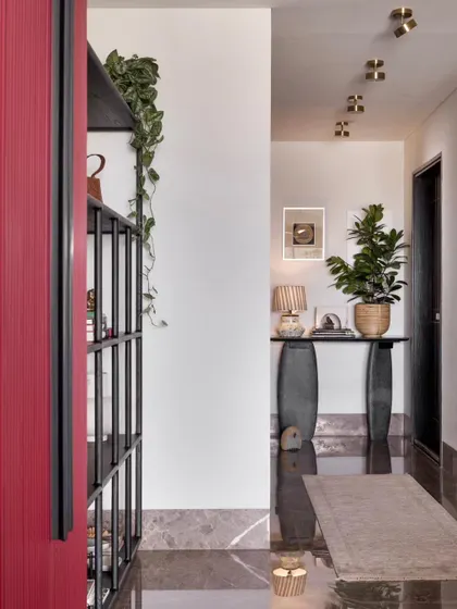 A view past the bar cabinet down the art-filled corridor.