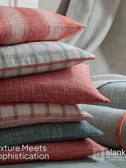 Texture meets sophistication in the 'Atlas' fabric collection. This image shows a stack of cushions in elegant checks, herringbones, and stripes, inspired by rustic landscapes but designed for modern homes.