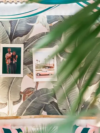 A detail shot within the retro-themed lounge, focusing on the wicker pendant lights and the personal photos of the couple that adorned the walls.