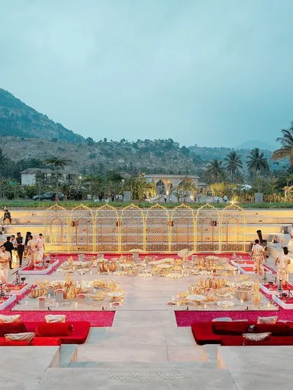 'Gadda' seating in rich maroon velvet was provided for guests to watch the Varmala ceremony in comfort, arranged on the steps of an amphitheater.