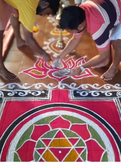 The intricate process of creating a rangoli with colored powders. This art form is a meditative practice that focuses the mind and beautifies the sacred space.