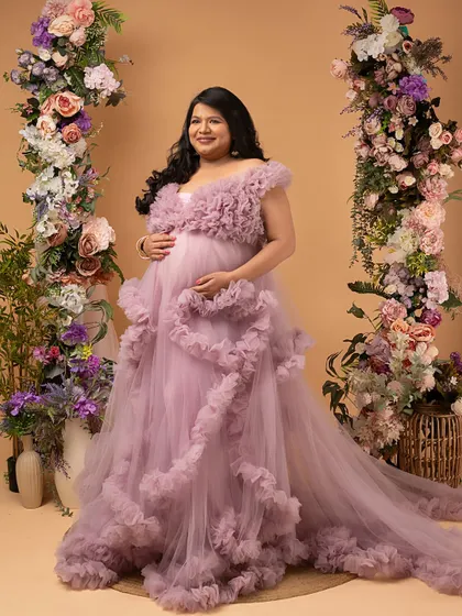 A portrait of a warrior. This mother of twins is wearing a stunning ruffled gown, a symbol of the beautiful victory after a challenging journey. Her strength is palpable.