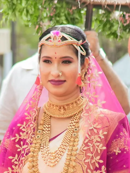 A candid shot of the bride during her ceremony. The makeup is designed to be long-lasting and beautiful, even under a sheer veil.