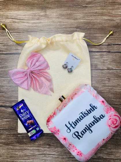 I can also customize the printed clutch with a name and a floral design, as shown in this Rakhi combo for a sister.