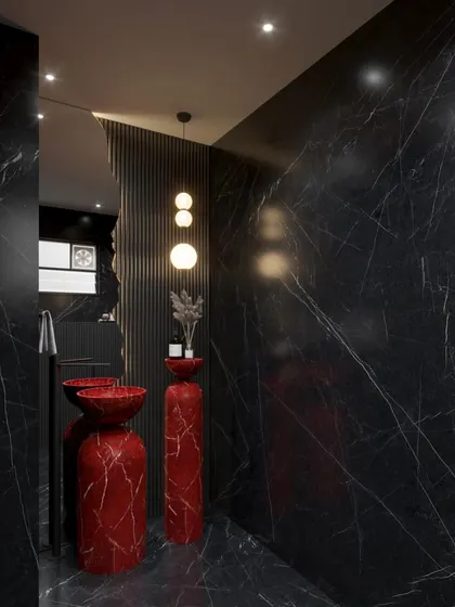 Another view of the red and black marble powder room concept. The irregular-shaped mirror and minimalist pendant lights balance the dramatic stone, adding a touch of modern elegance.