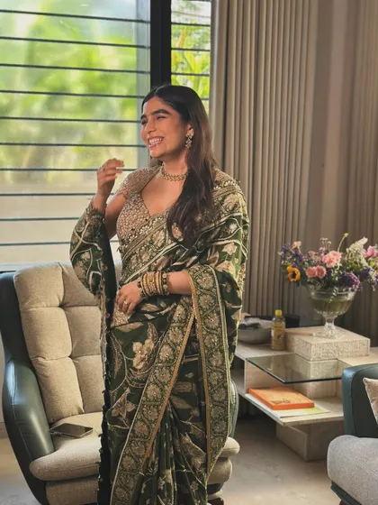 Regal, radiant, and utterly beautiful. Our gorgeous bride Kinjal in an exquisite green floral saree by Gazal Gupta for one of her pre-wedding festivities.